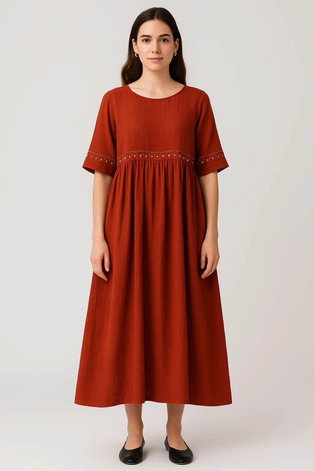 Woman wearing a rust-colored dress with decorative hem 