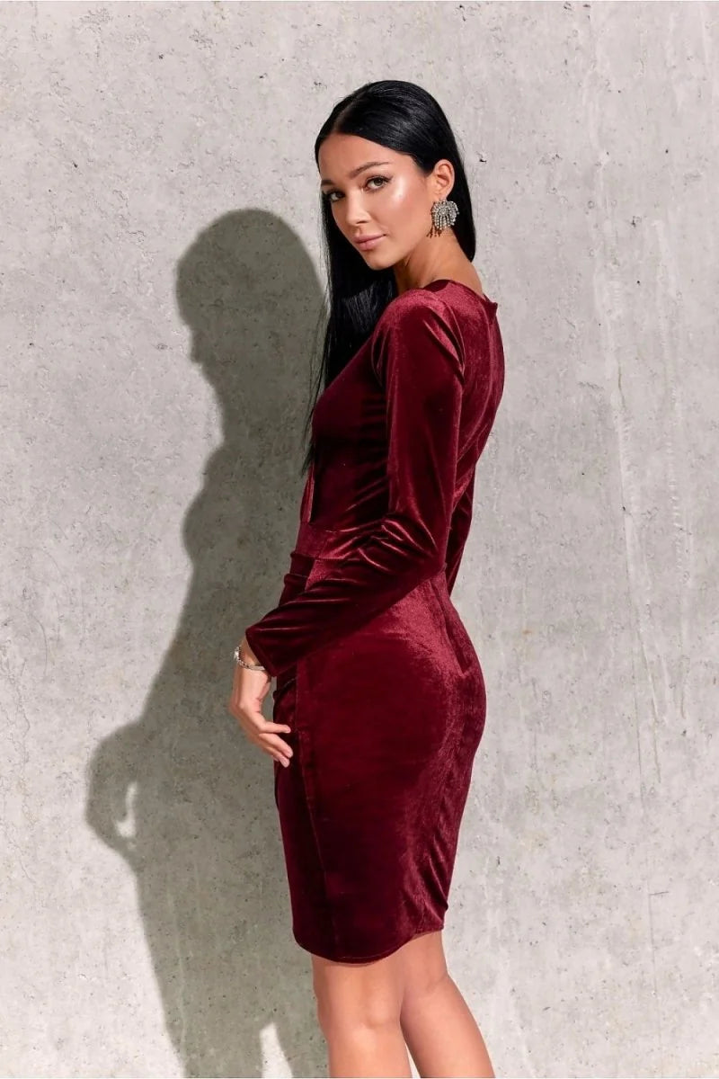 Fitted burgundy velvet dress with long sleeves, showcasing a subtle sheen and a flattering silhouette.