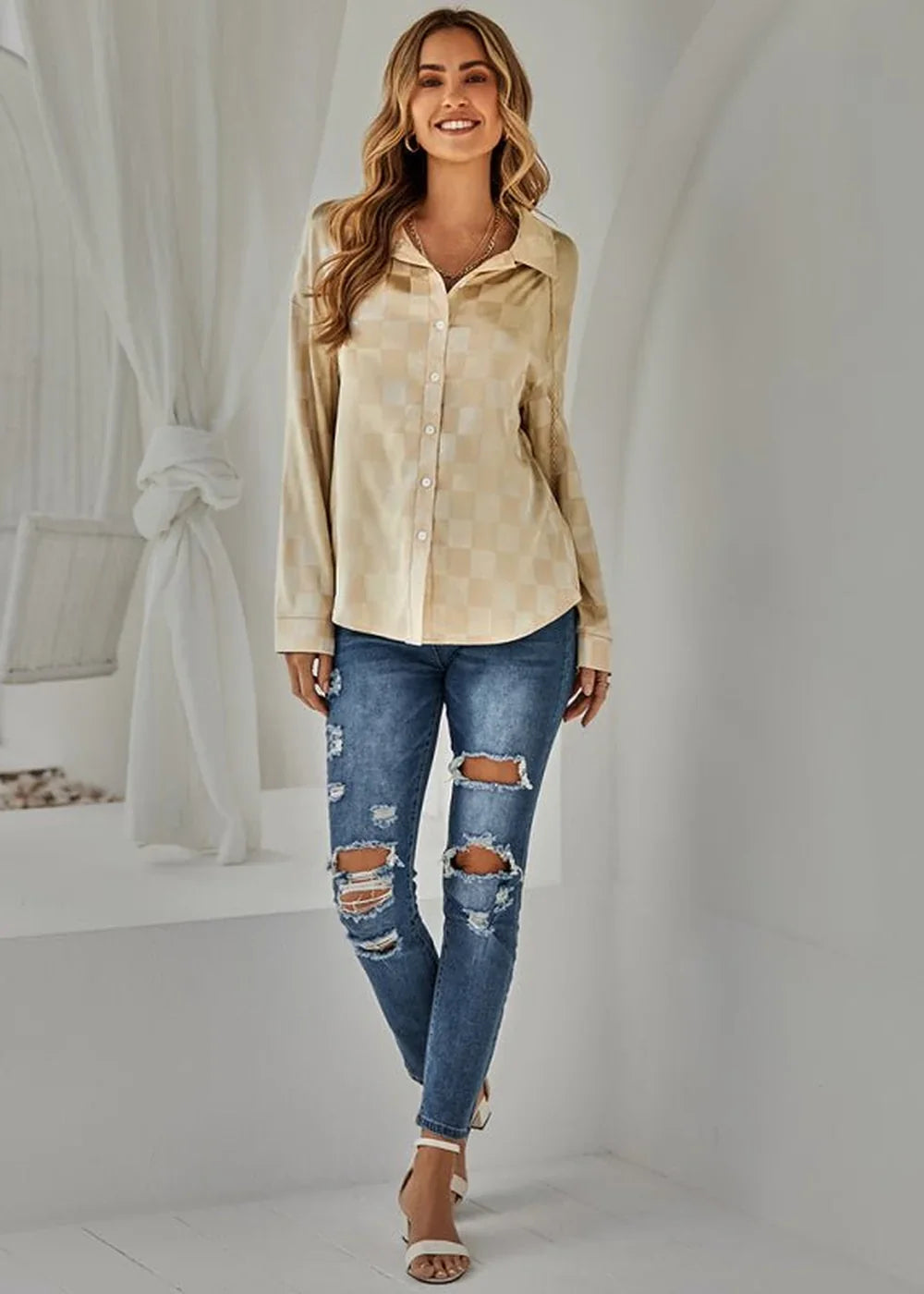 Tan and cream checkered long-sleeve button-up shirt on model with distressed denim jeans.