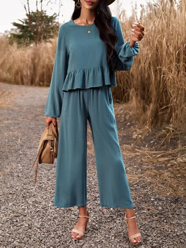 Teal linen-blend wide-leg pant suit with ruffled peplum top, worn by a model outdoors.
