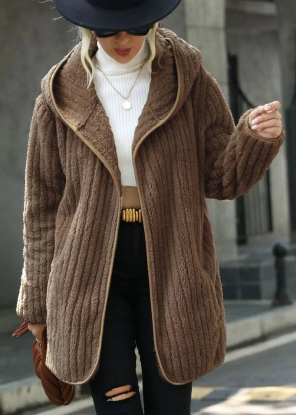 Brown textured teddy coat with a hood, open front, and trim detail on a model.