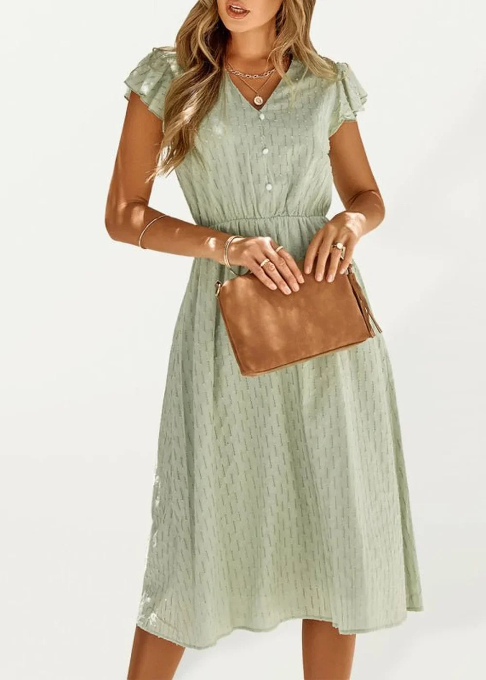 Light green midi dress with subtle patterned texture, short flutter sleeves, and a brown clutch.