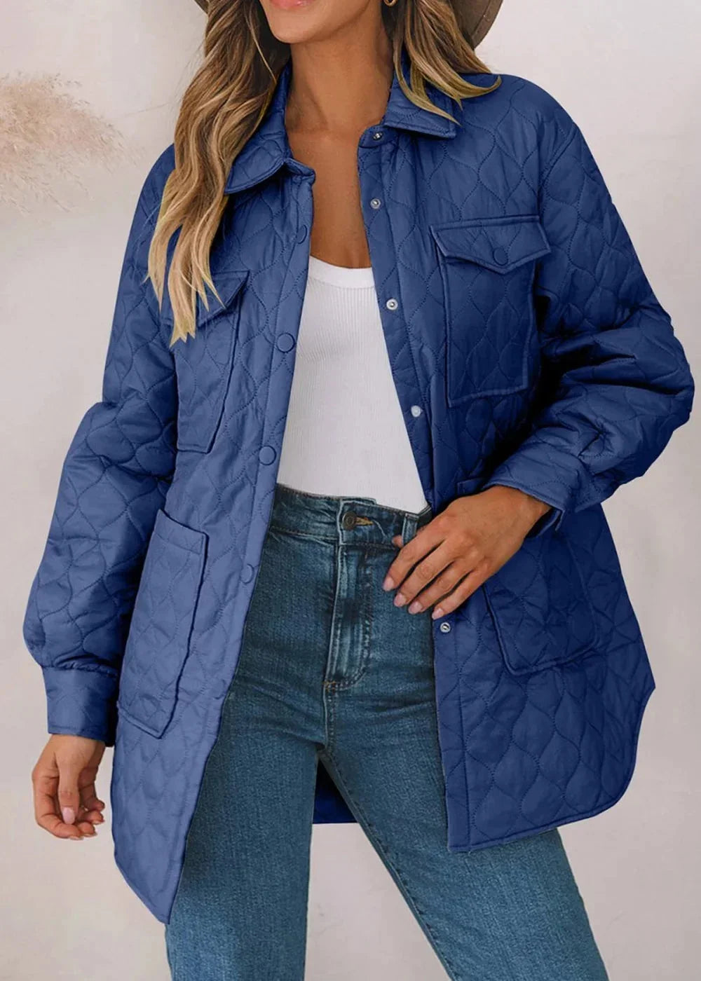 Quilted navy blue jacket with button front and chest pockets on model