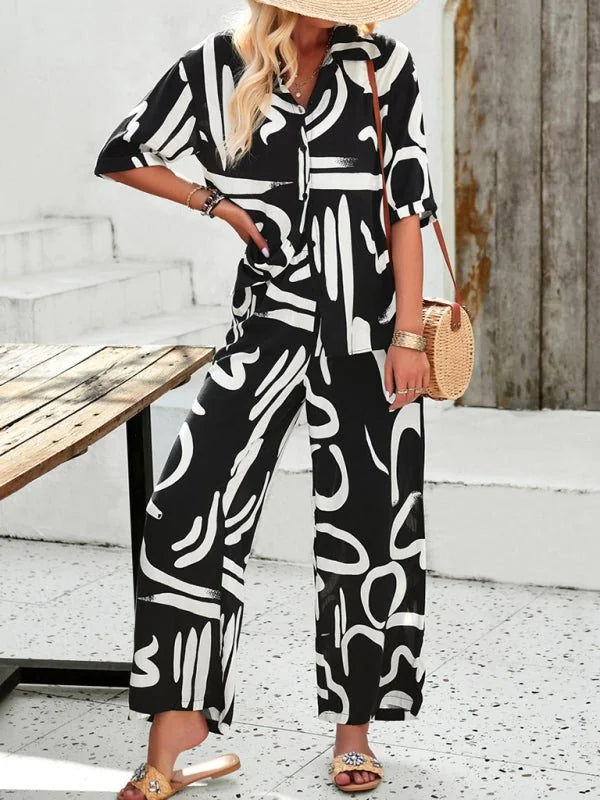 Black and white abstract print viscose fiber pant suit with a collared shirt and wide-leg pants.