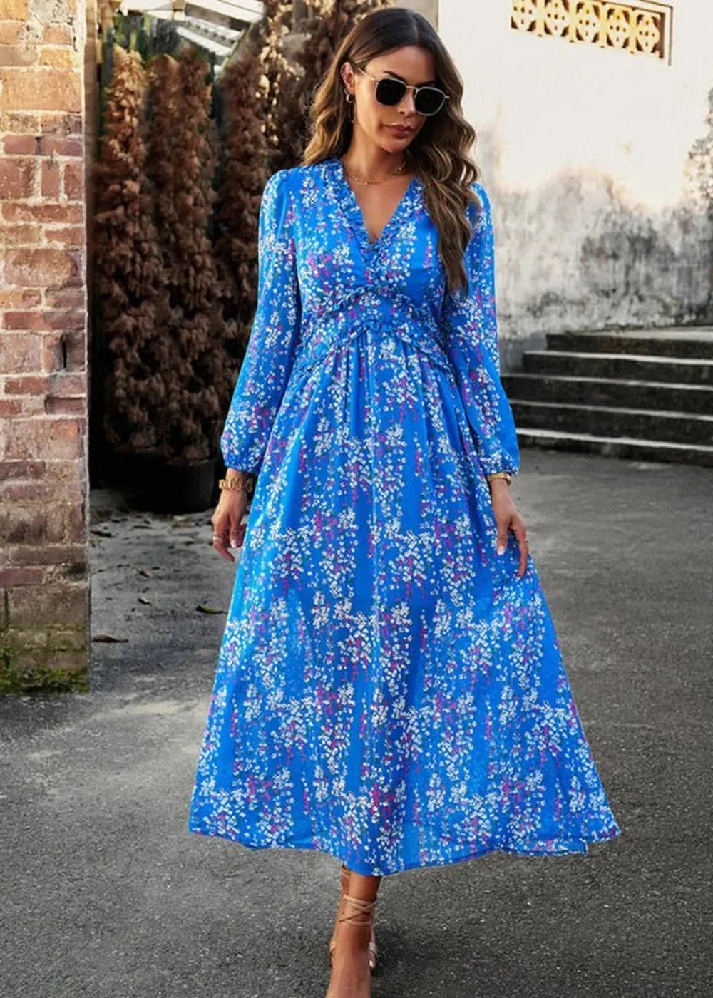 Blue floral print maxi dress with v-neck and long sleeves on a model.