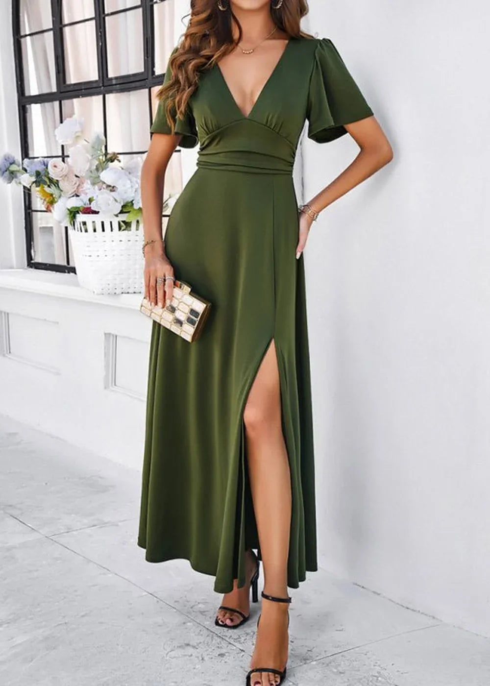 Olive green maxi dress with a V-neck, flutter sleeves, and a high slit, shown on a model.