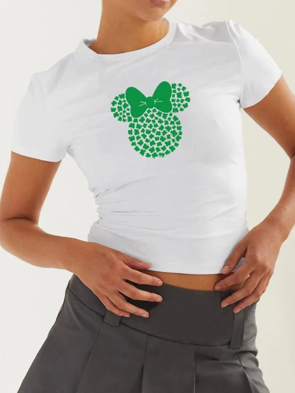 White t-shirt with a green Mickey Mouse head graphic made of shamrocks and a green bow.
