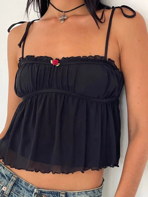 Black babydoll cami with ruffled trim and a small red rose detail.