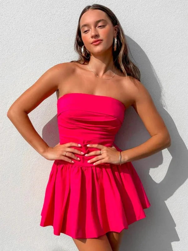 Bright pink strapless mini dress with a ruched bodice and flared skirt.