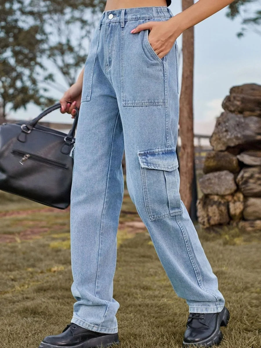 Light wash denim cargo pants with a relaxed fit, featuring large front pockets and a textured fabric.