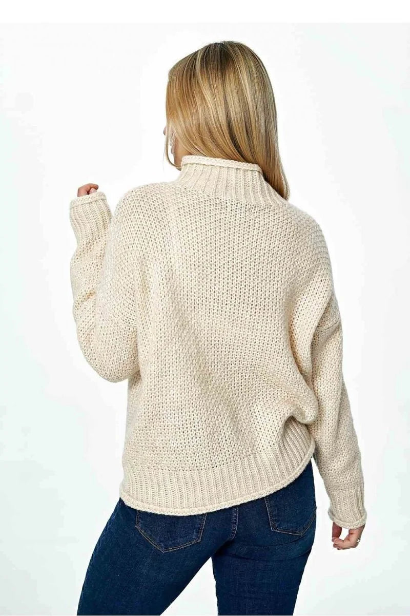 Cream knit turtleneck sweater with ribbed cuffs and hem, shown from the back on a model.