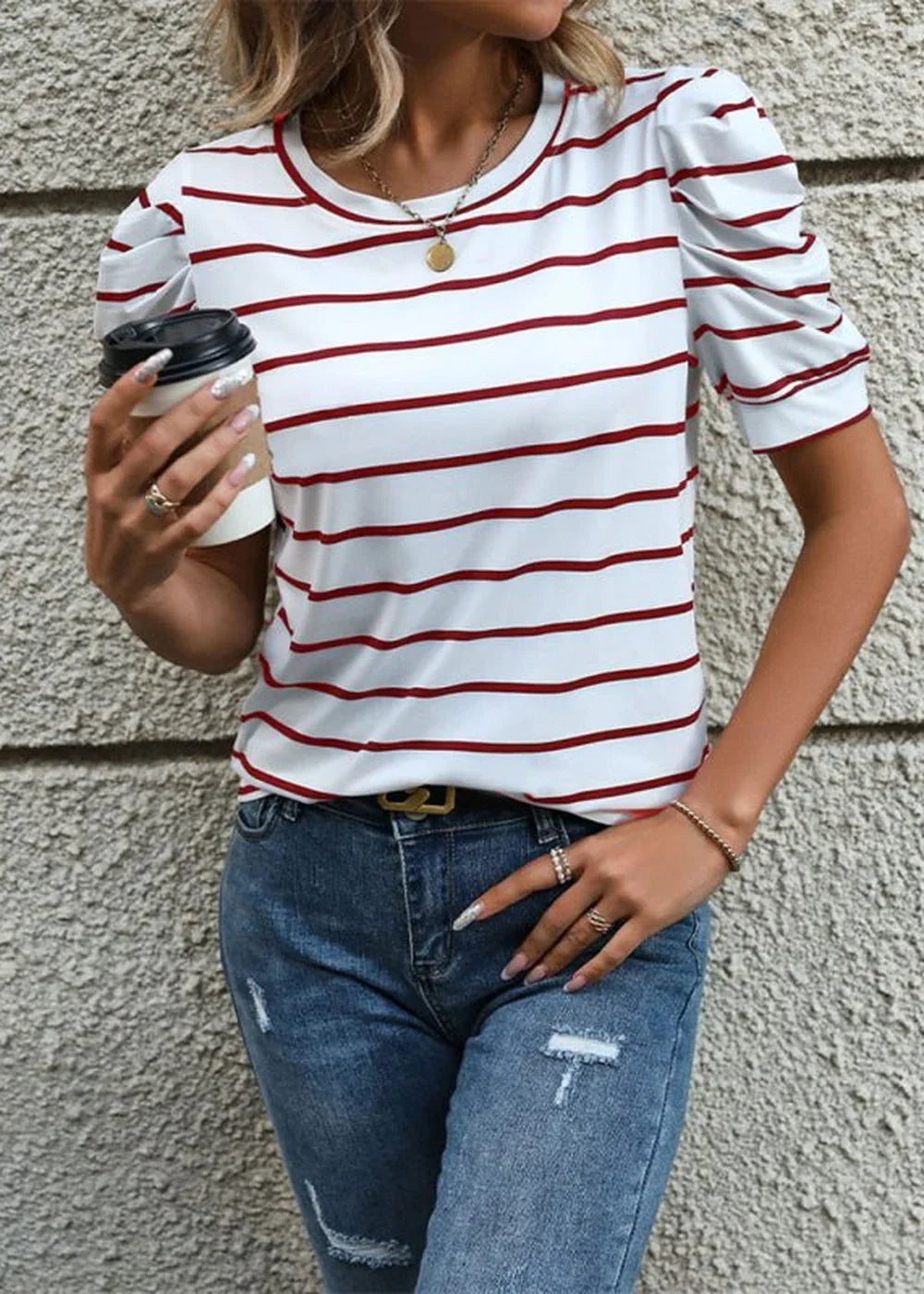 White and red striped t-shirt with puff sleeves and a gold pendant necklace.
