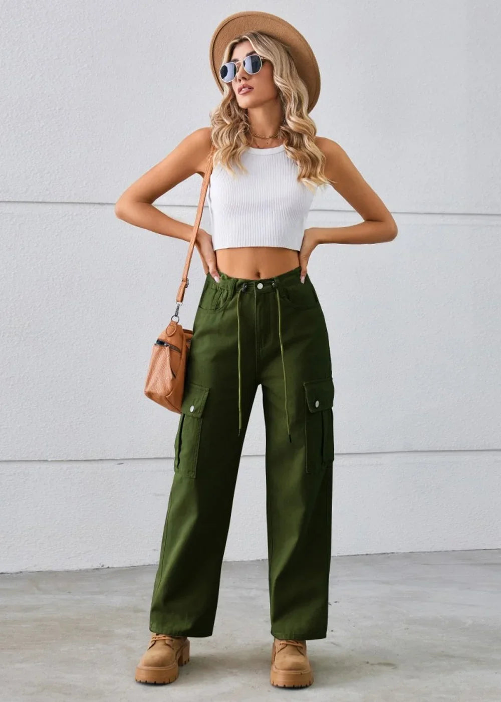 Olive green cargo pants with drawstring waist and side pockets, on model.