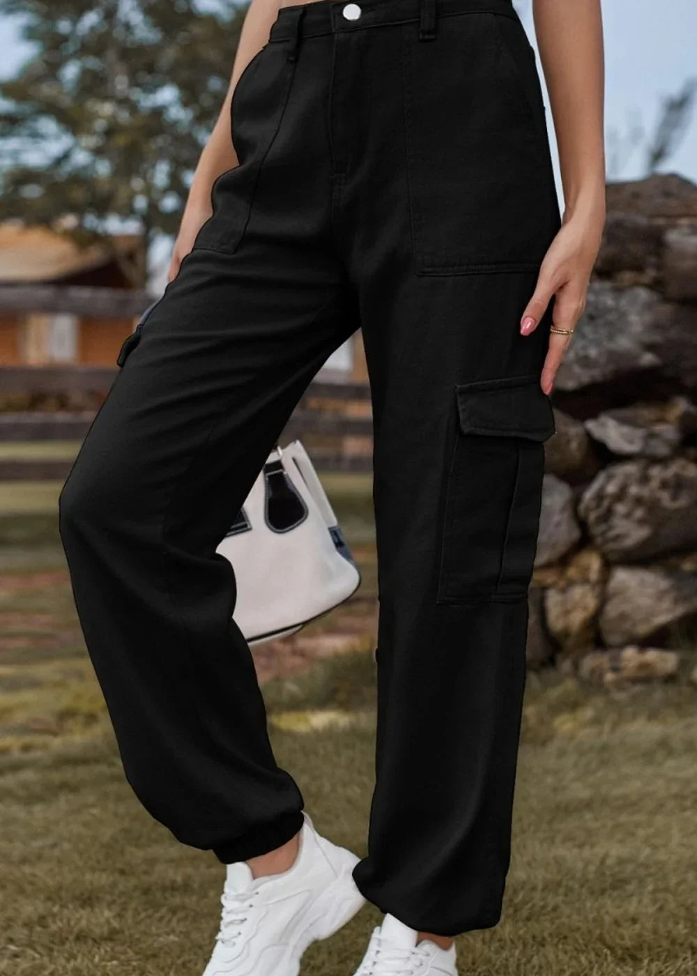 Black cargo pants with a regular fit, featuring large side pockets and cuffed ankles.