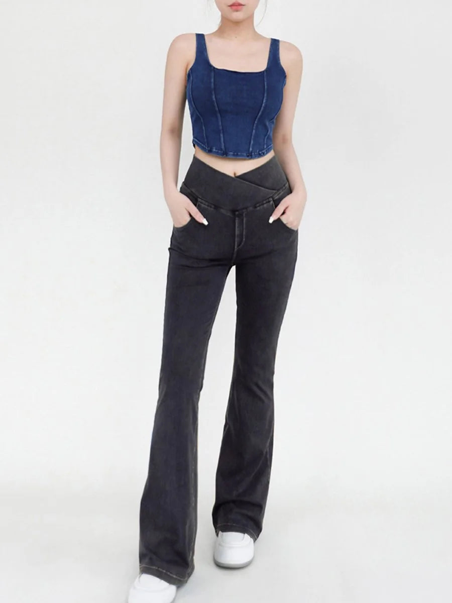 Dark wash flared jeans with a unique crossover waistband detail, shown on a model.