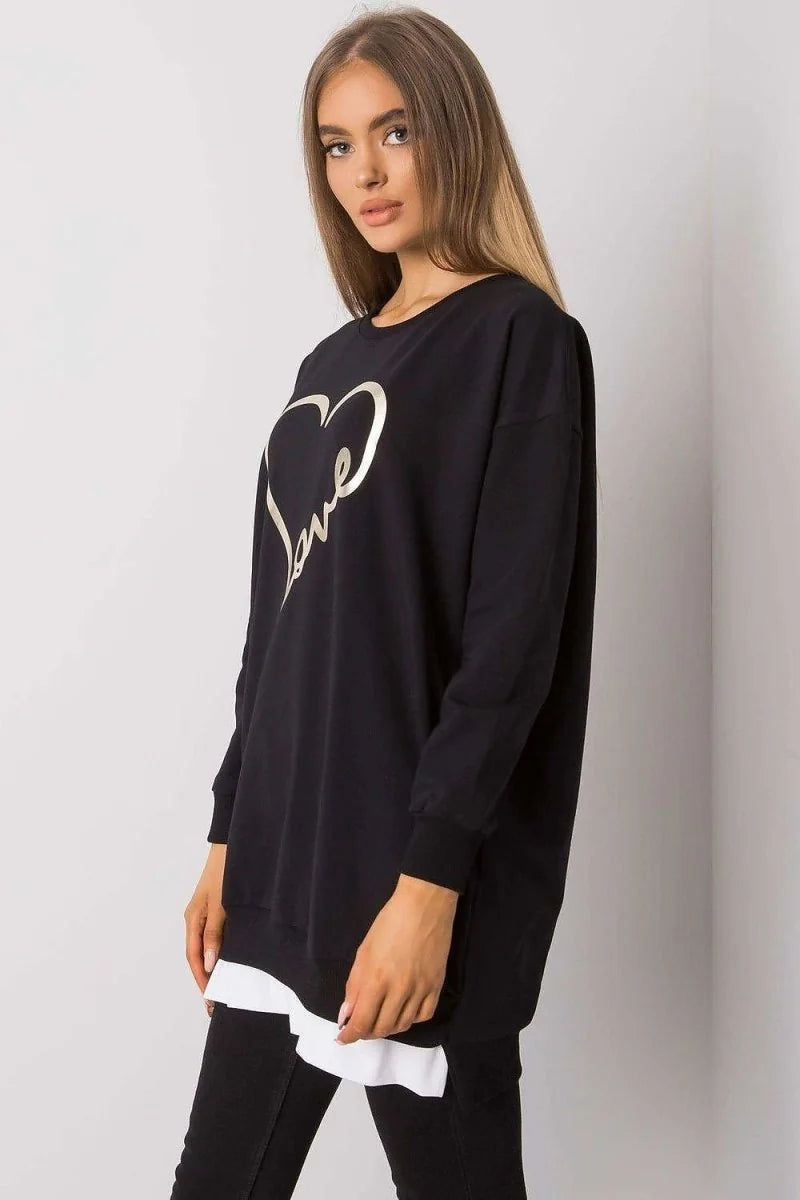 Black tunic sweatshirt with gold heart and "love" print, layered over white shirt, on model.