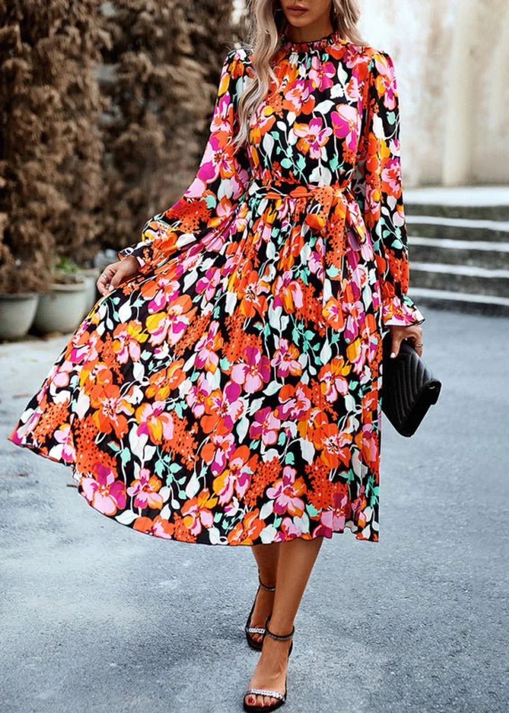 Vibrant floral print midi dress with a cinched waist, long sleeves, and a flowy skirt.