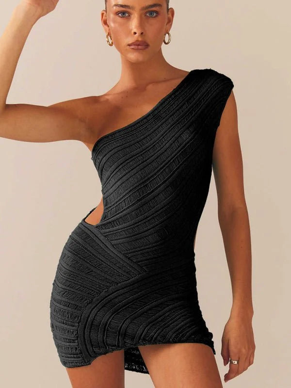 Black one-shoulder mini dress with textured, diagonal ribbing and a cut-out detail on the side, on a model.