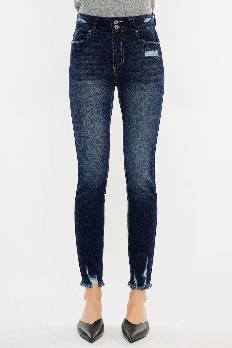 Dark wash denim jeans with frayed hem, distressing, and a double button closure.