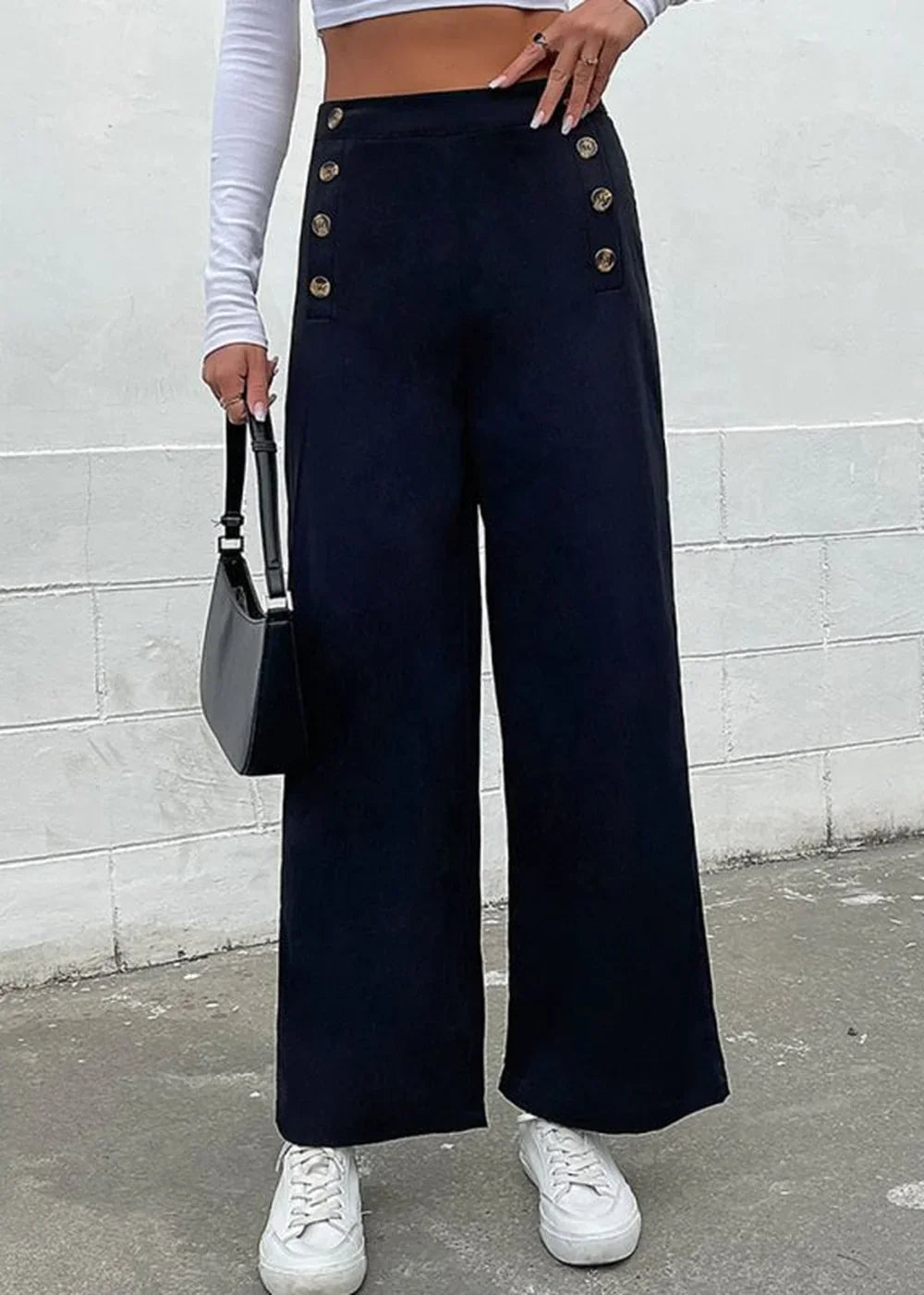 Navy blue wide-leg pants with gold button details and a smooth texture, shown on a model.