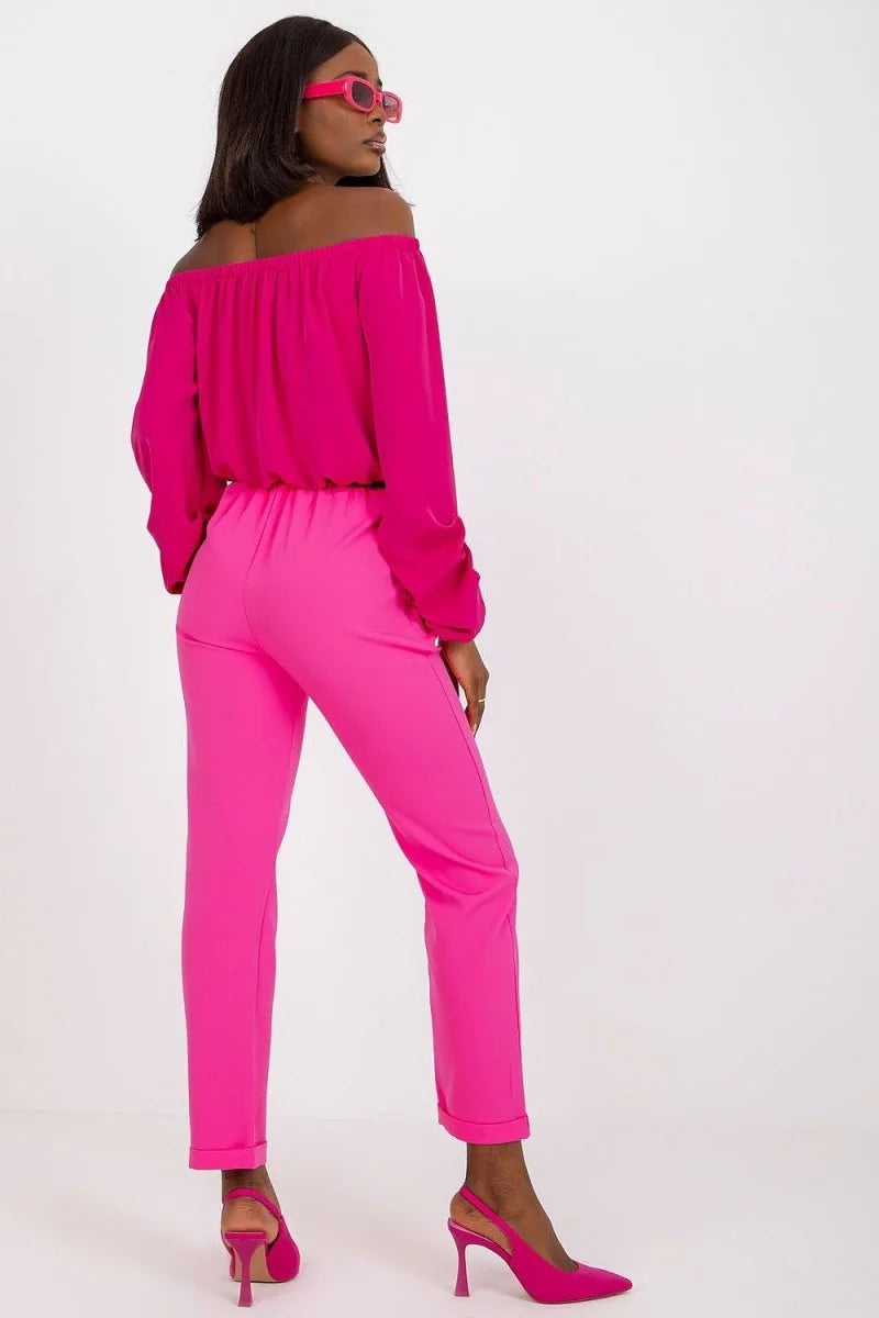 Hot pink, off-the-shoulder top and matching high-waisted pants with cuffed hems.