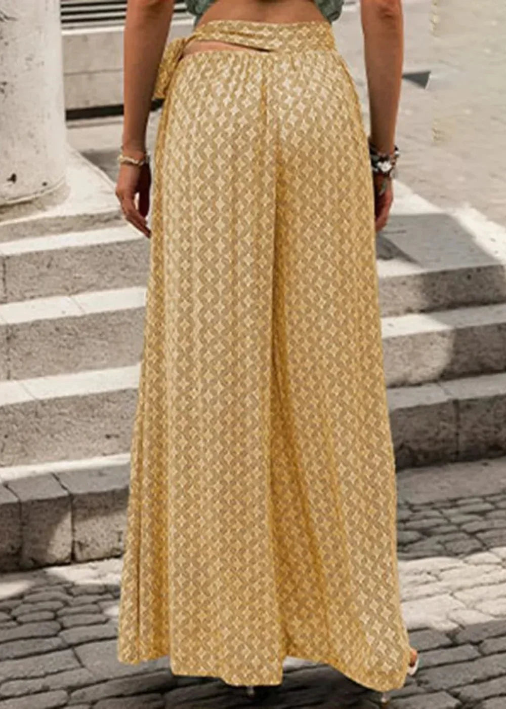 Yellow wide-leg pants with a geometric pattern and wrap waist detail.
