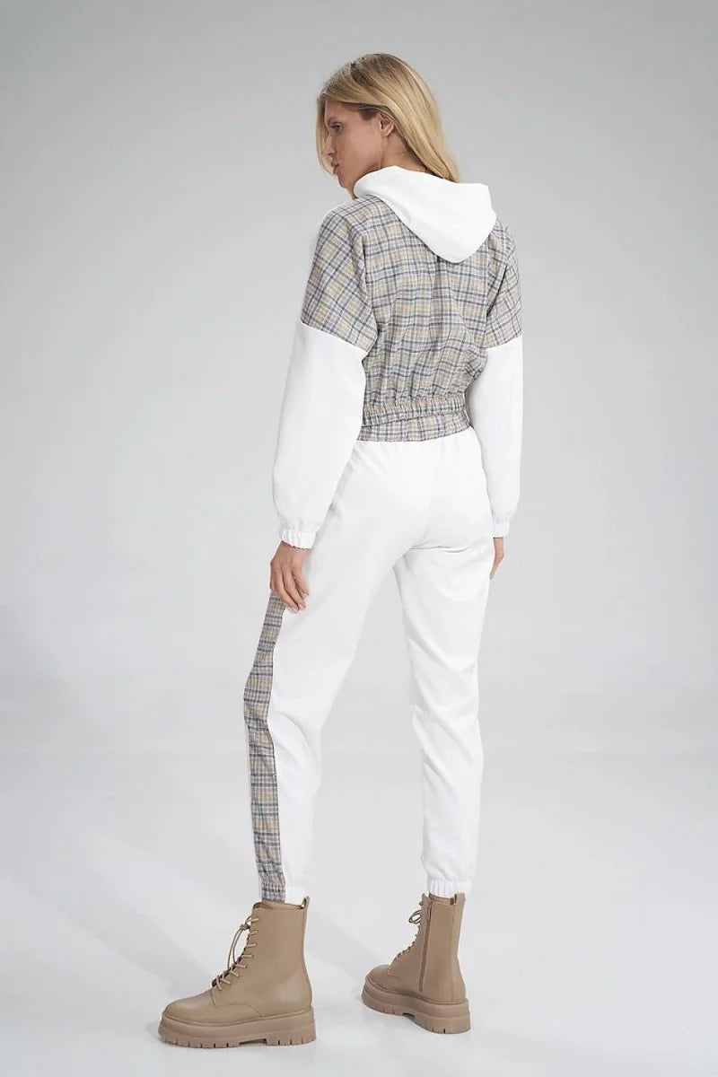 Woman from behind in white joggers with plaid stripe detail and a plaid crop hoodie.