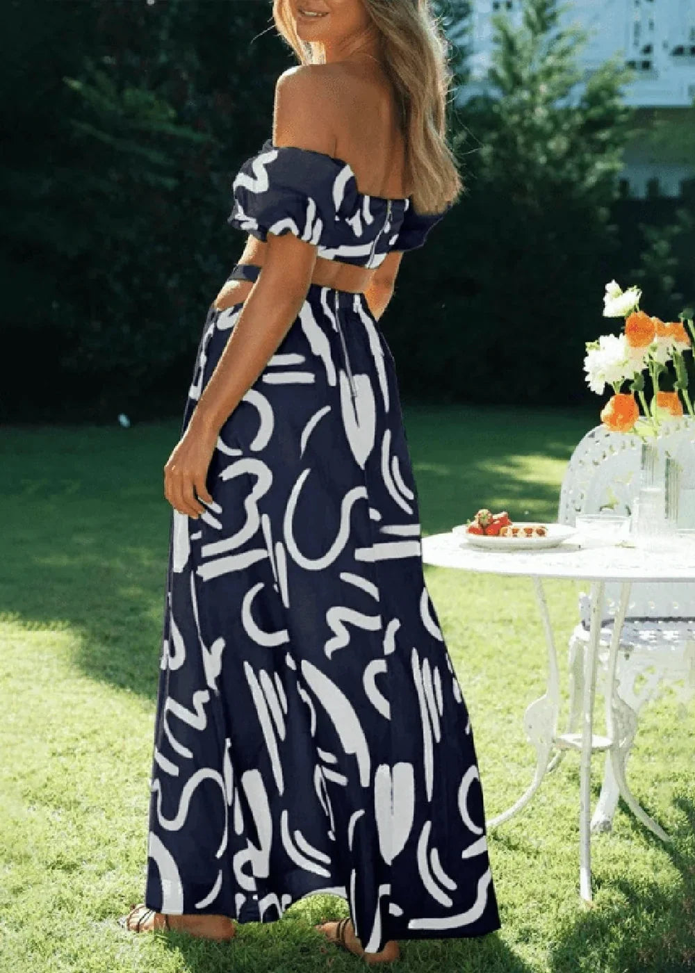 Navy blue and white abstract print maxi skirt with a ruffled hem.