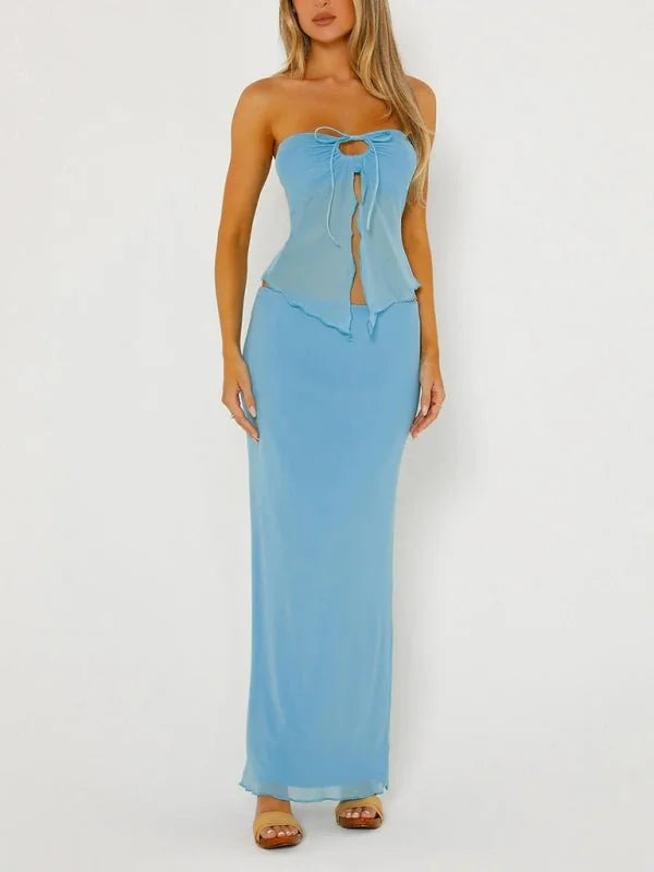Light blue strapless top and maxi skirt set on model, showing sheer fabric and tie detail.