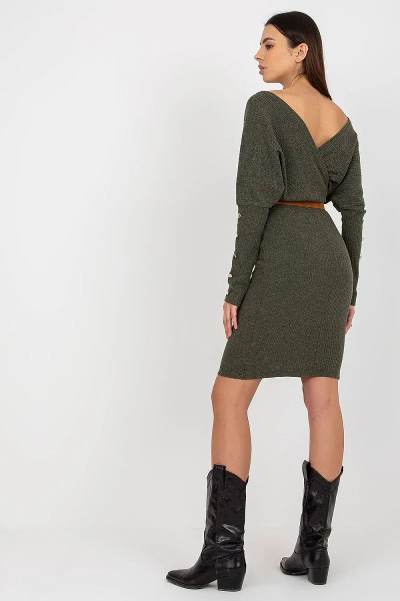 Olive green ribbed knit dress with a V-neck, cinched waist belt, and button details on the sleeves, worn with black cowboy...
