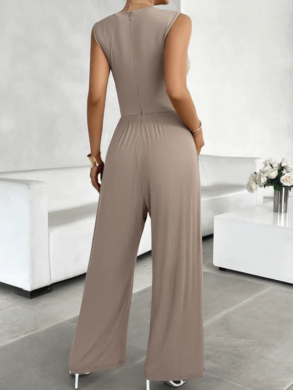 Back view of a taupe viscose fiber jumpsuit with wide legs and a seamless design.