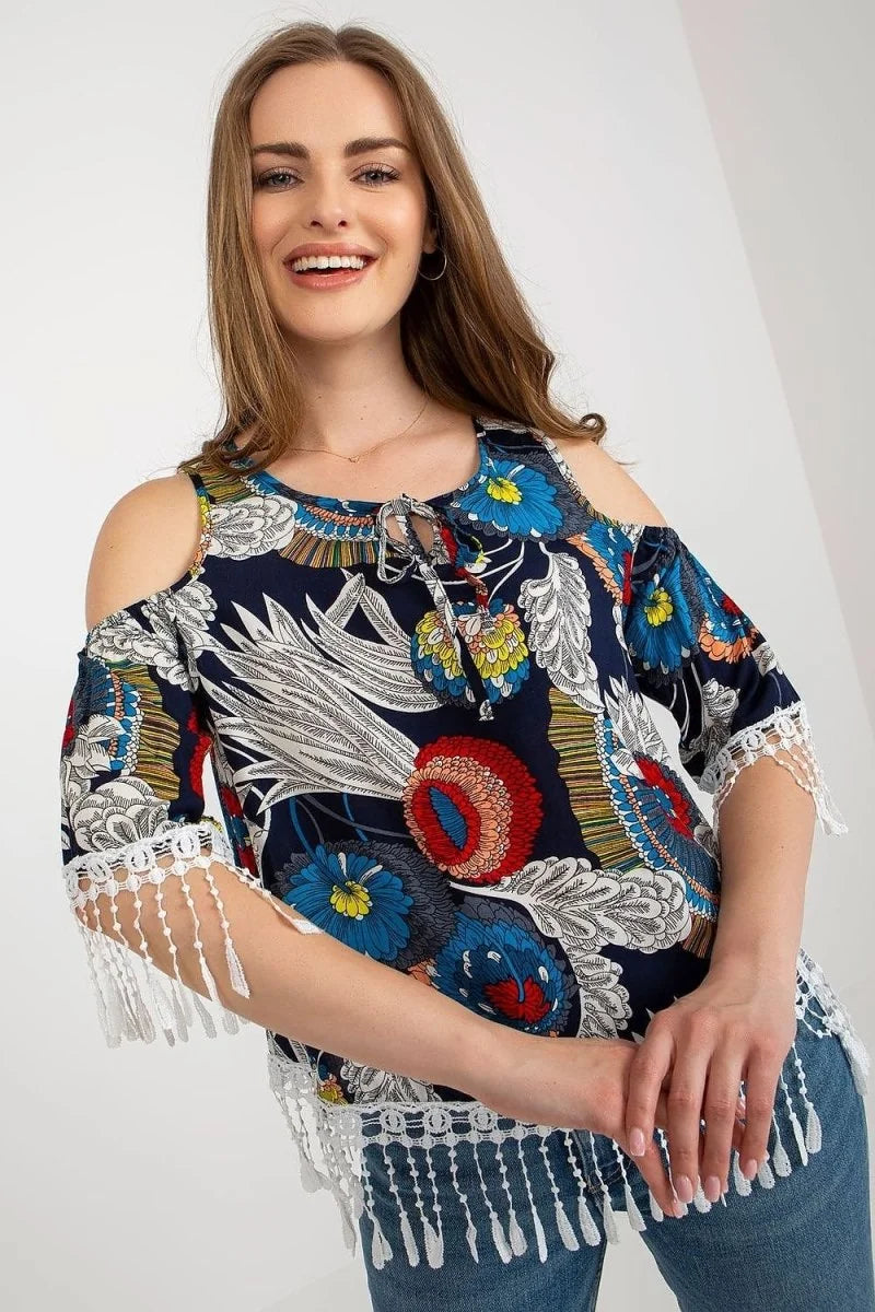 Navy blue cold-shoulder top with vibrant floral print and white lace fringe trim.