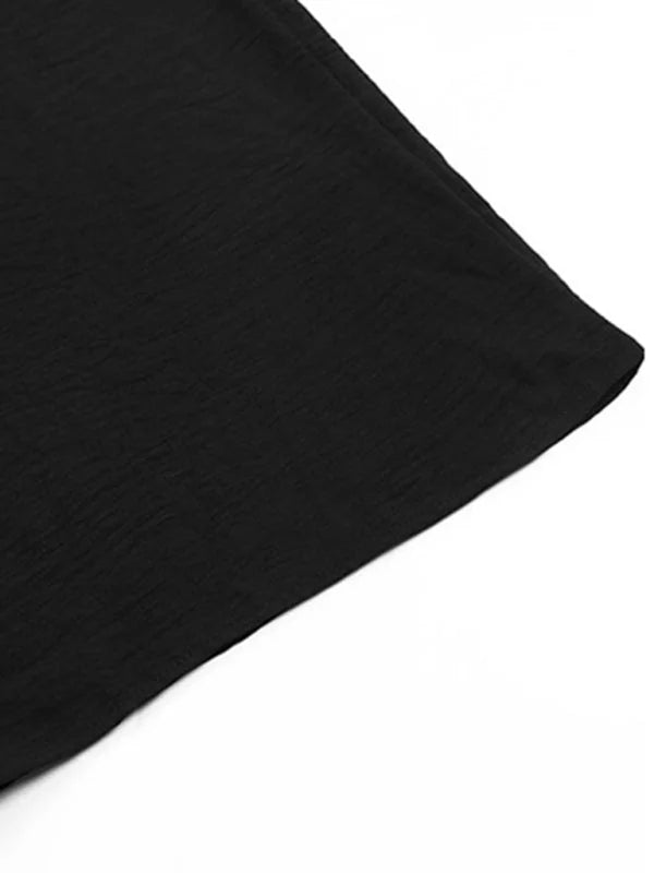 Close-up of black textured fabric with a crinkled finish.