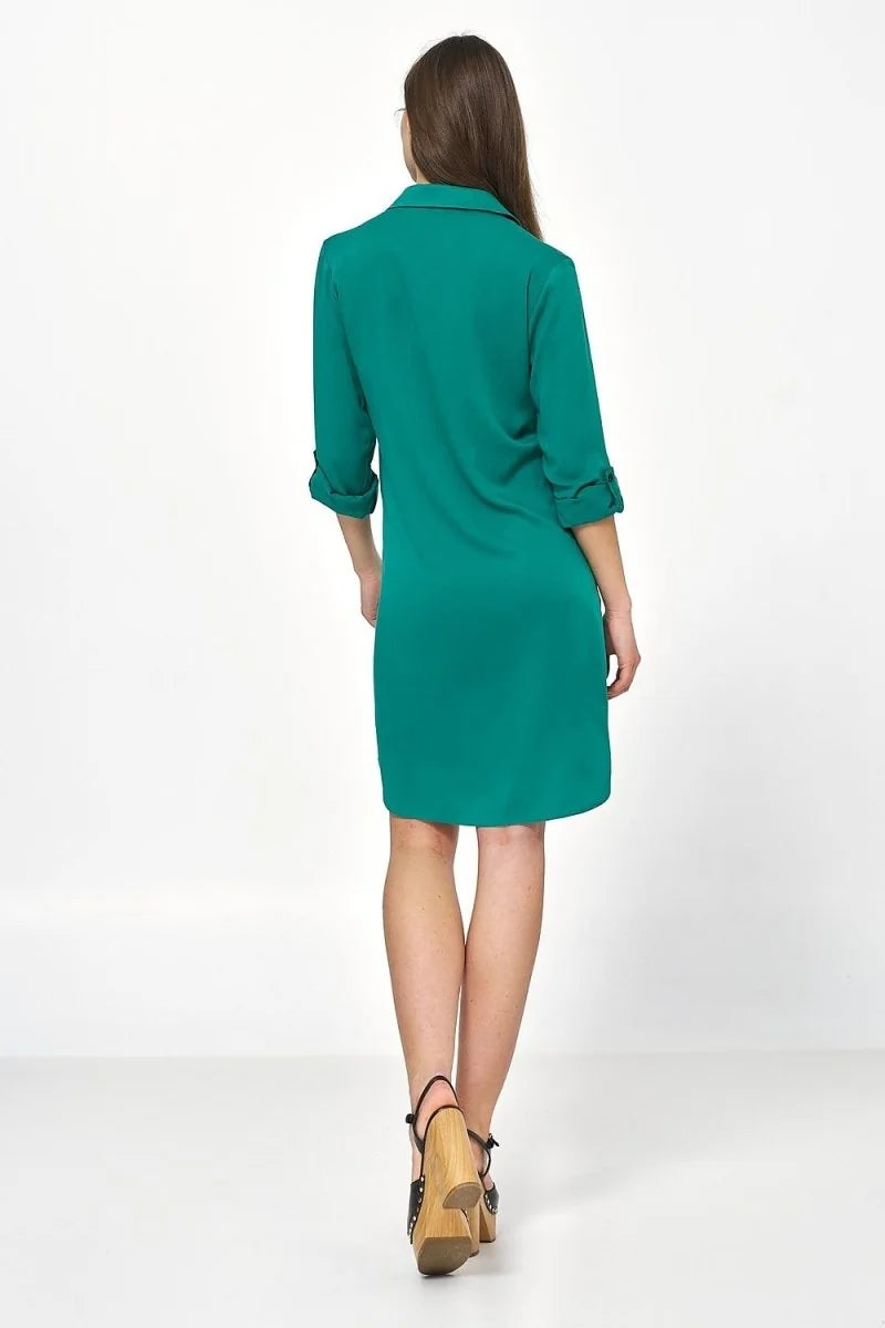 Back view of a teal green, oversized fit, 3/4 sleeve shirt dress with rolled cuffs.