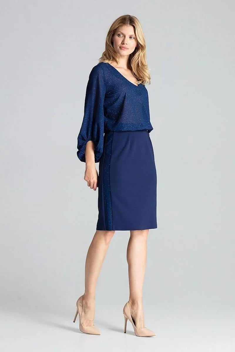 Navy blue pencil skirt with a glitter stripe detail on the side, worn with nude heels.