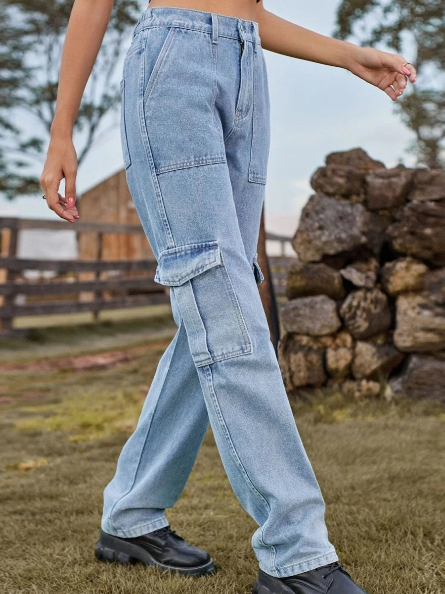 Light wash denim cargo pants with multiple pockets, relaxed fit, on model.