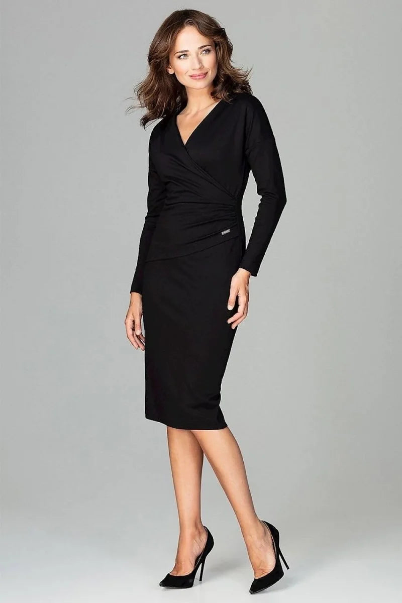 Full-length black wrap dress with ruched waist and V-neck, worn by a model with black heels.