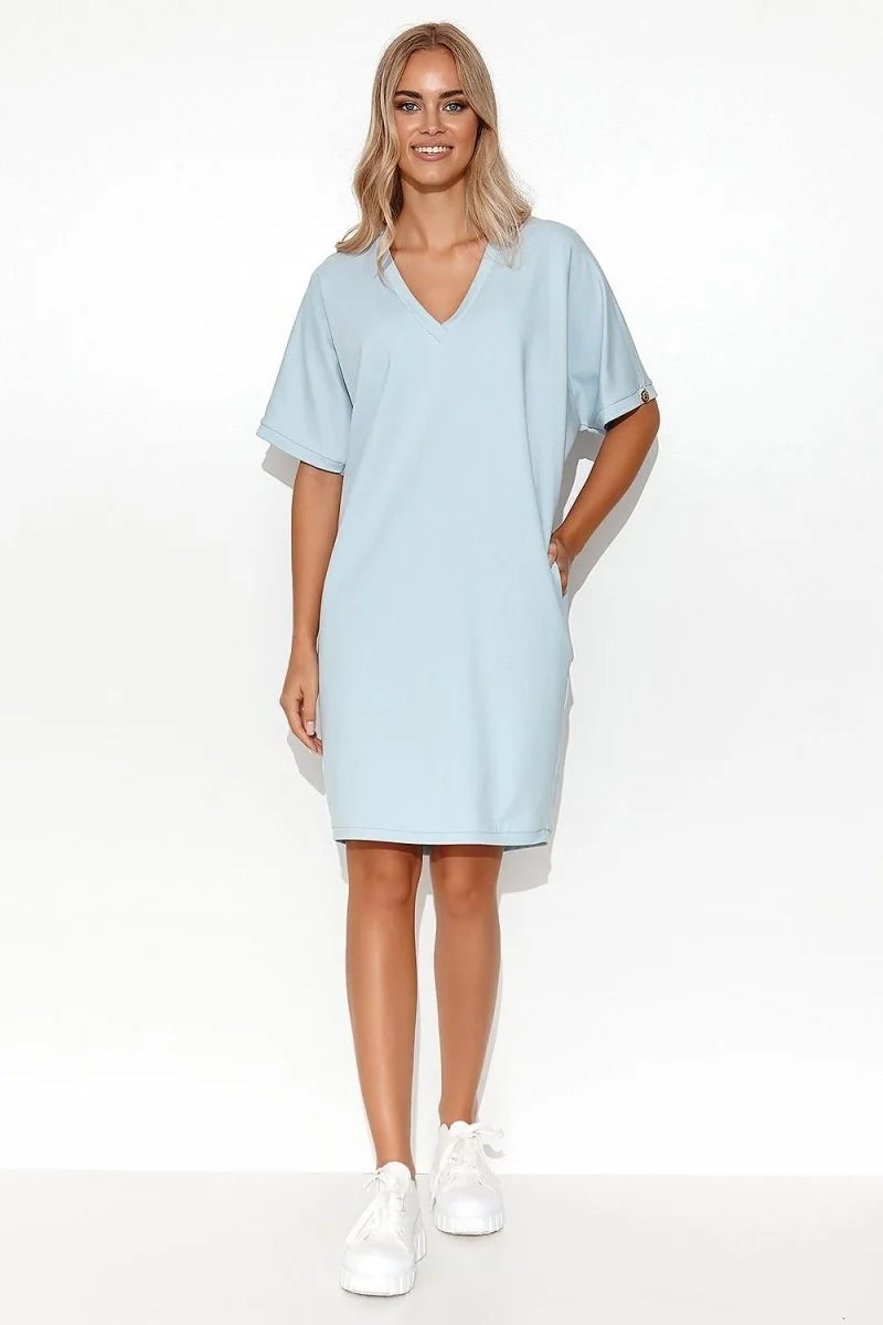 Light blue v-neck short-sleeve cotton-blend day dress with white sneakers on model.