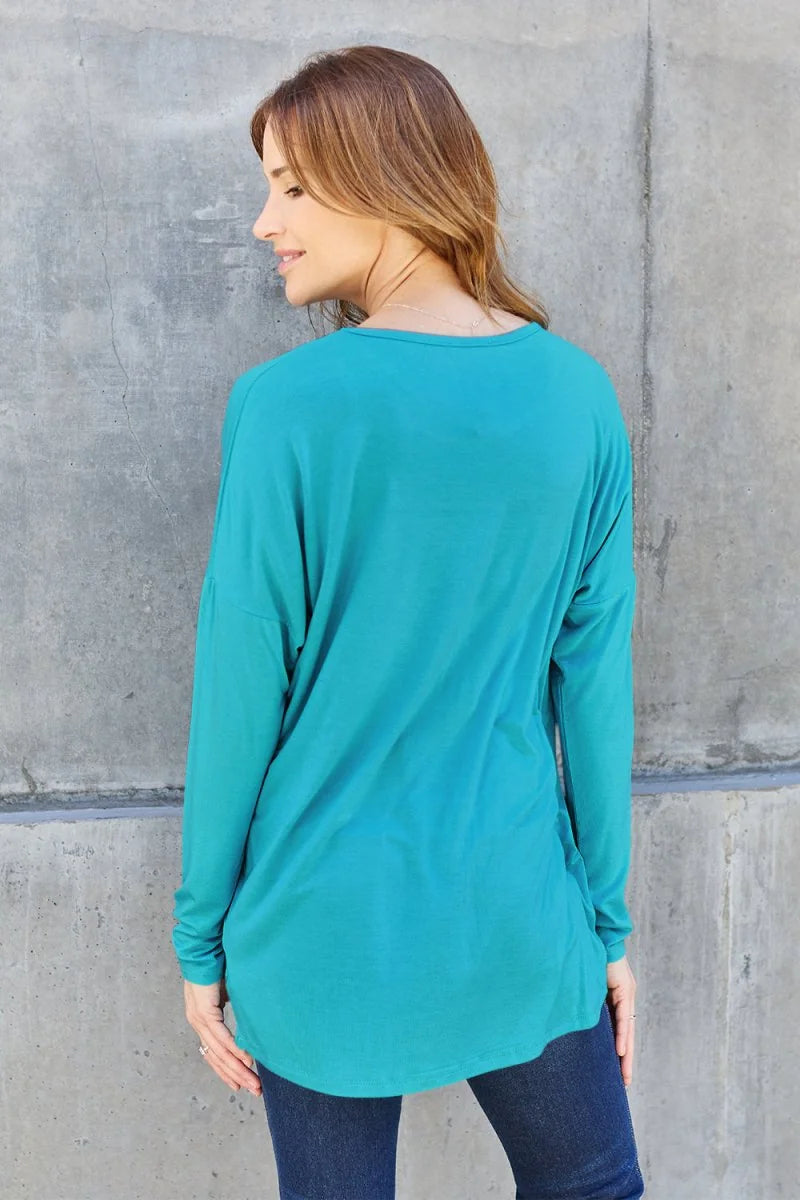 Back view of a teal long-sleeve top made of soft rayon and spandex blend, on a model.