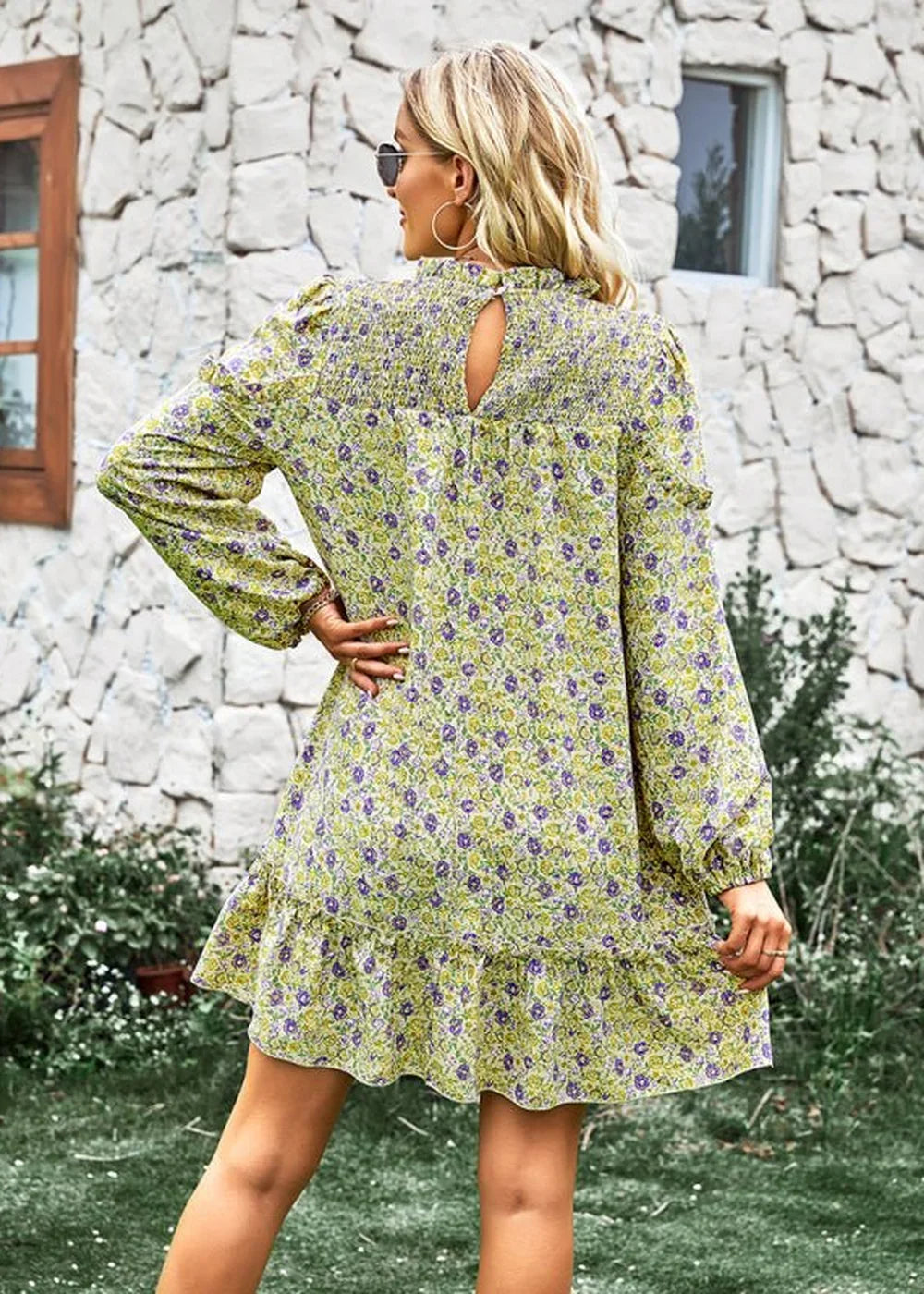Light green floral print dress with a ruffled hem, long sleeves, and a keyhole back.