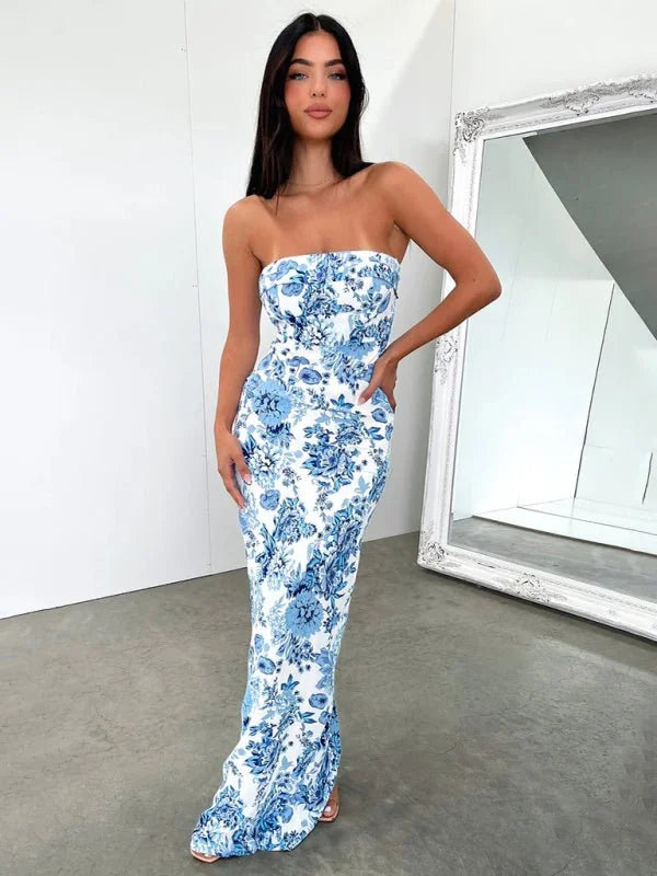 Strapless maxi dress with a blue floral pattern on white fabric, fitted silhouette.