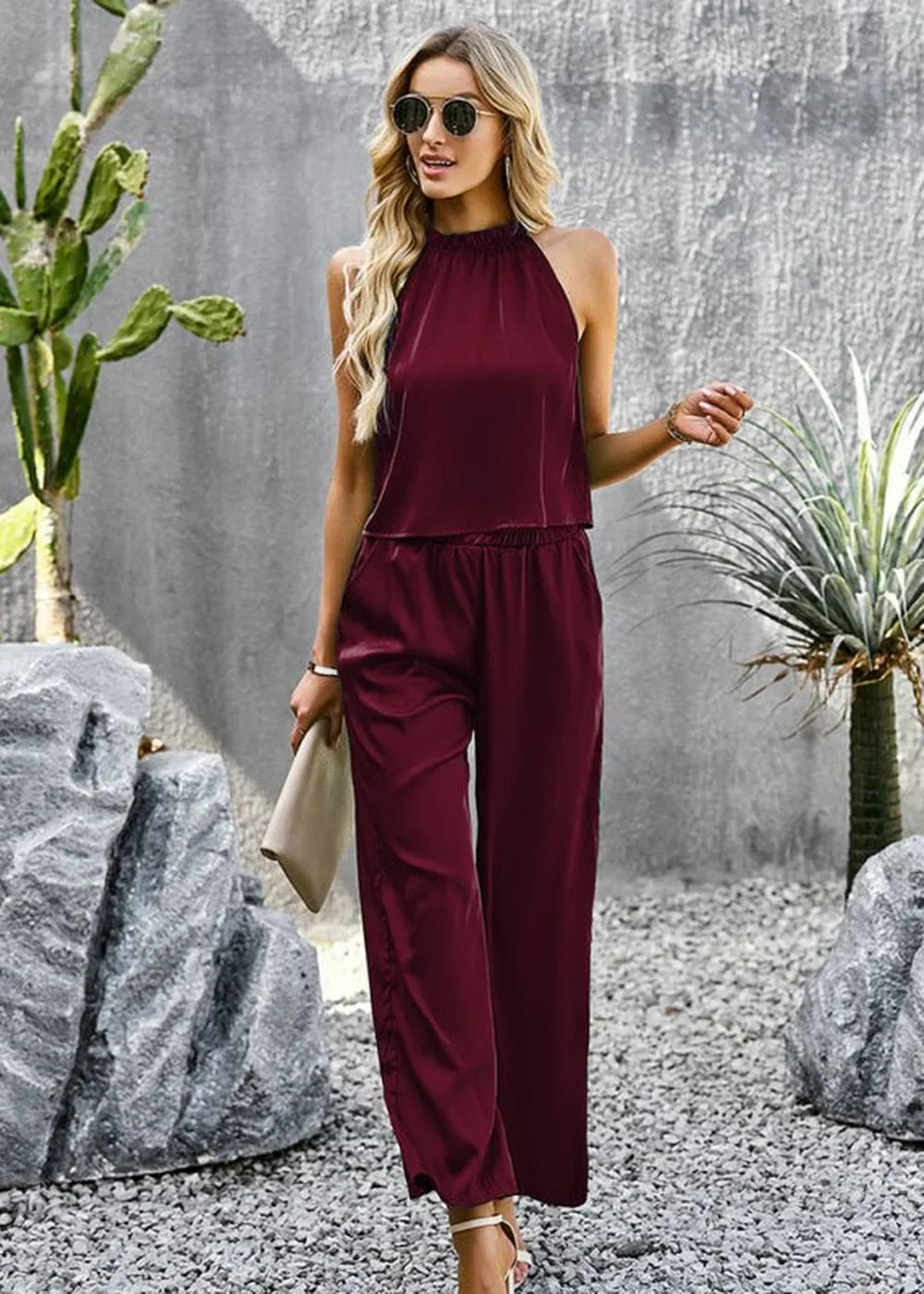 Burgundy satin halter top and wide-leg pants set with a relaxed fit, on a woman with blonde hair.