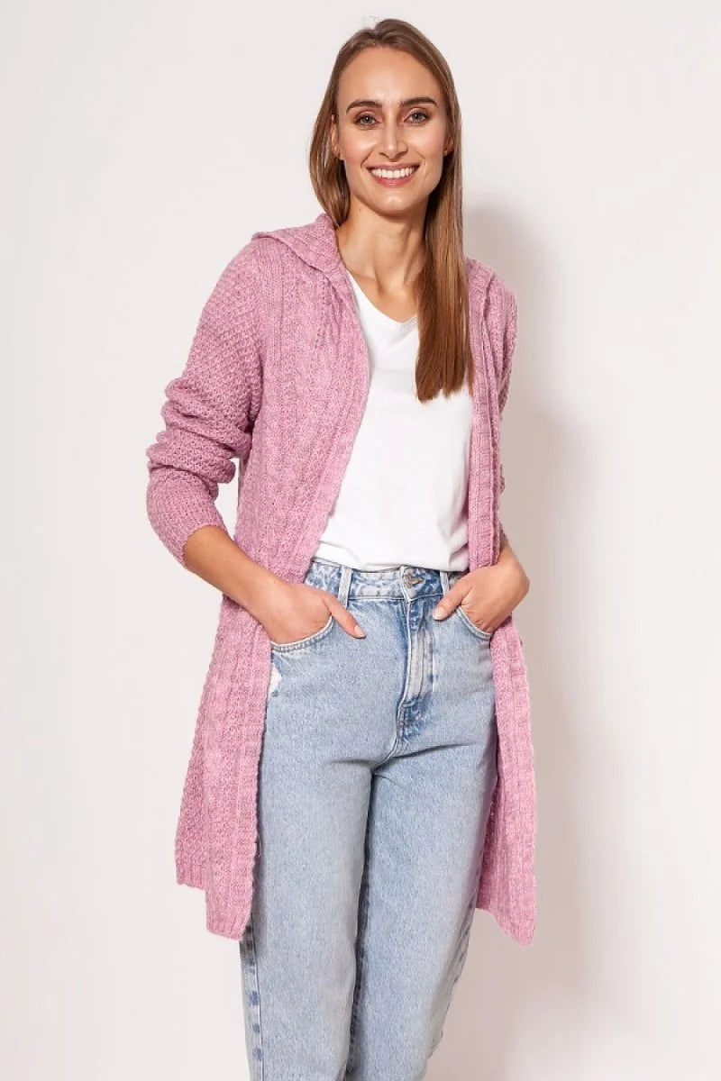 Pink hooded cardigan with cable knit texture and a relaxed fit, worn by a woman in light blue jeans.