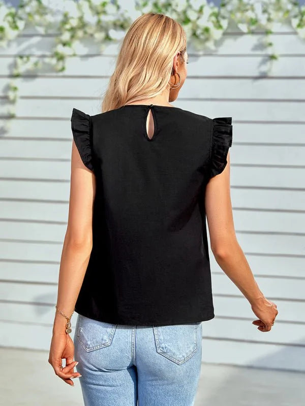 Black ruffled cap sleeve top with keyhole back, paired with light wash distressed denim jeans.