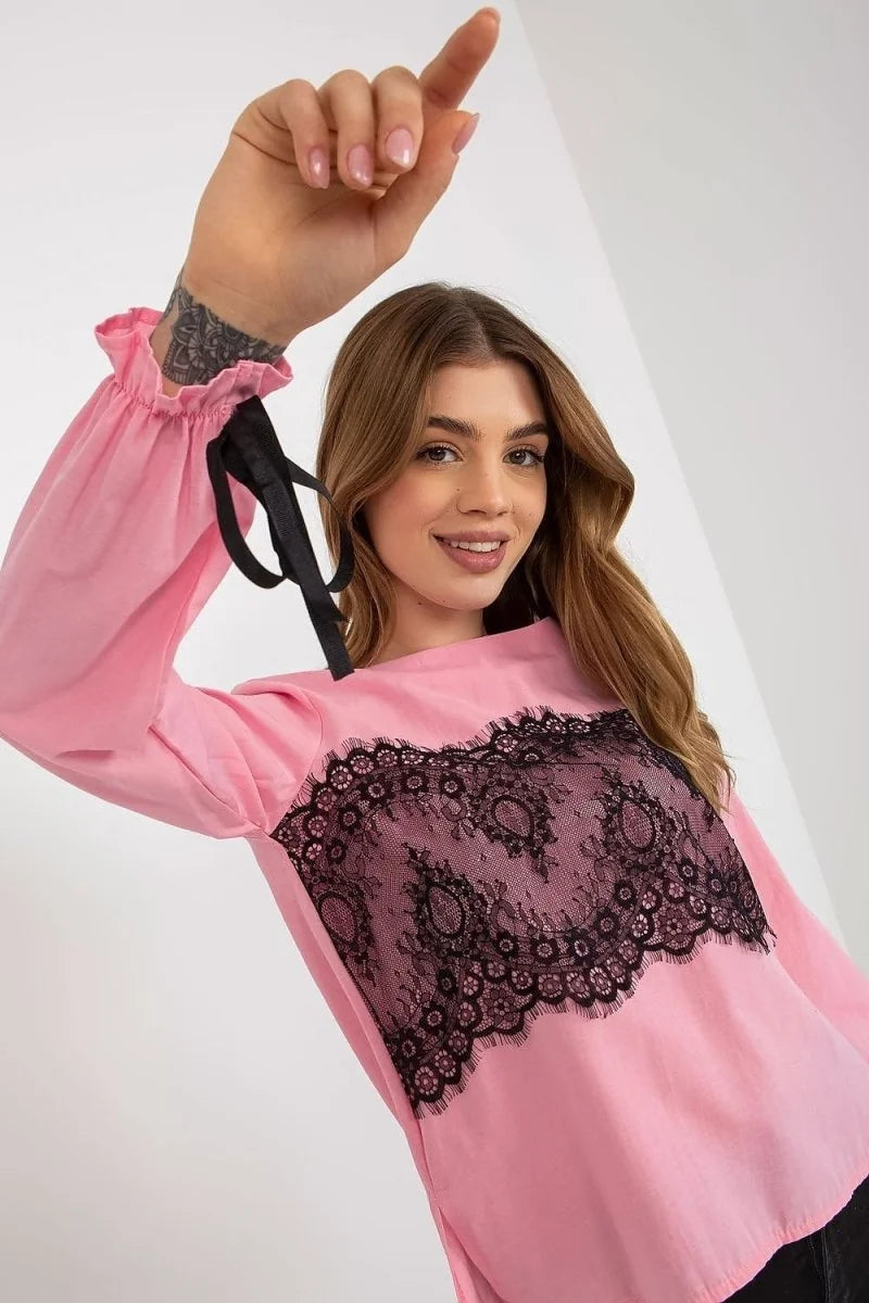 Pink long-sleeve top with black lace inset on chest and tie details on sleeves.