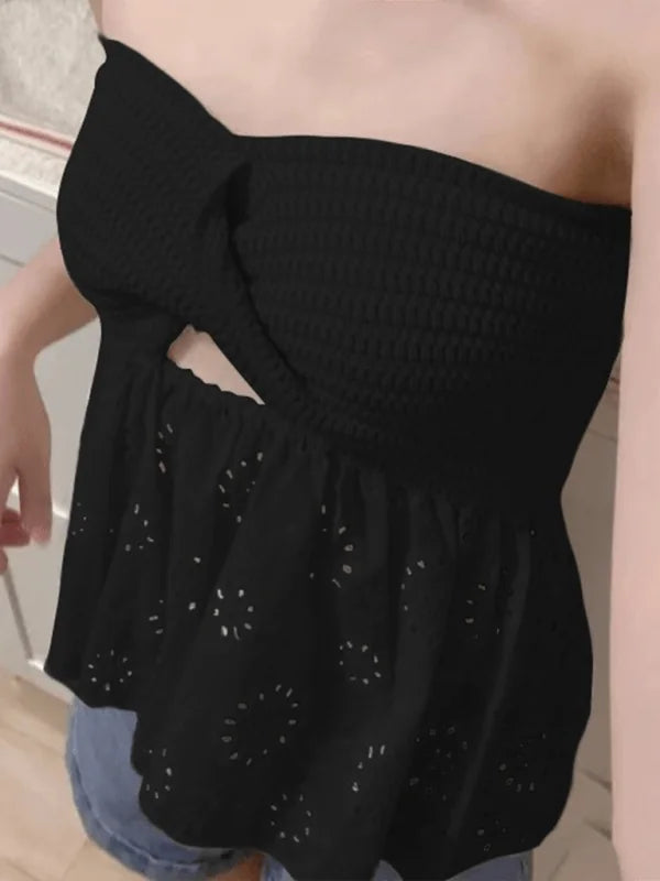 Black strapless peplum top with eyelet details and a knot front detail.