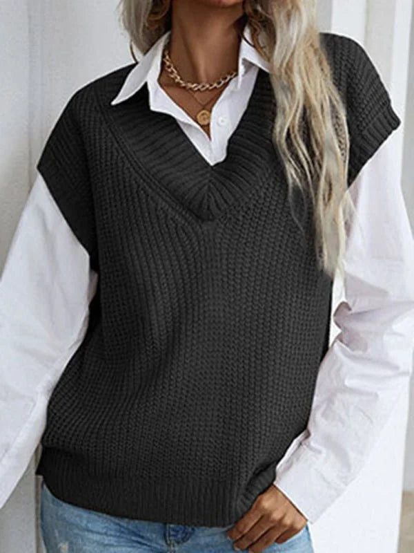 Dark grey knit v-neck vest over a white collared shirt, on a model.