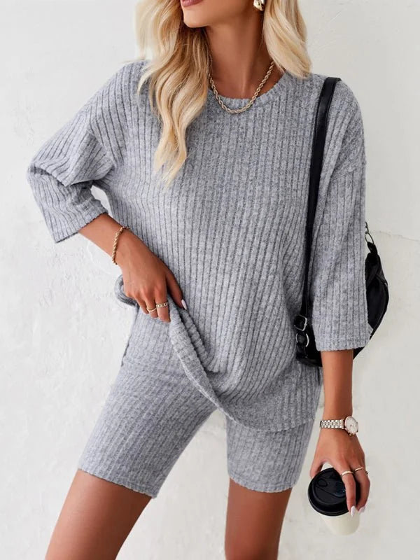 Grey ribbed knit loungewear set with crew neck top and biker shorts on model.