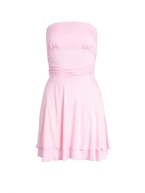 Light pink strapless mini dress with ruched bodice and tiered hem, on white background.