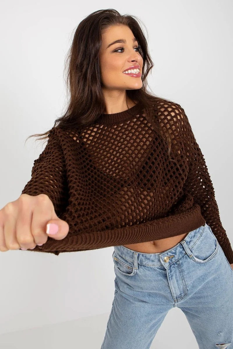 Cropped brown open-knit sweater with ribbed hem and cuffs, paired with light wash denim jeans on a model.